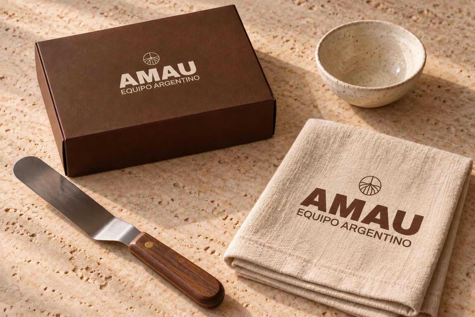 Conceptual AMAU kitchen kit with cocoa box, branded linen and pastry tool