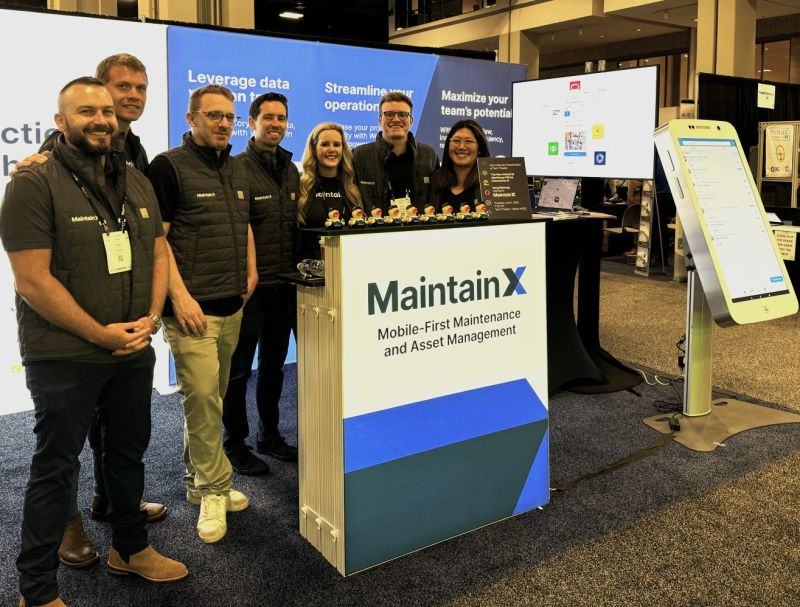 MaintainX team at a product demonstration booth with duck giveaways